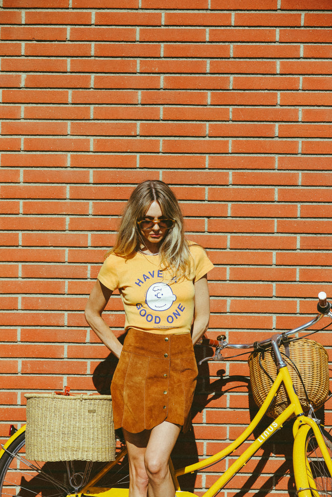 
                  
                    peanuts have a good one baby tee marigold
                  
                