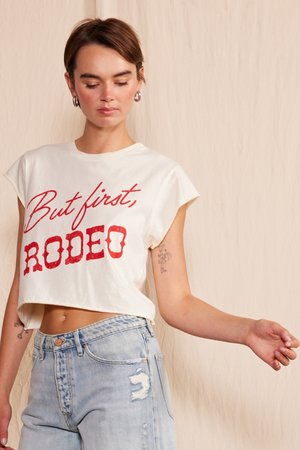
                  
                    "But First, Rodeo" Crop Top
                  
                